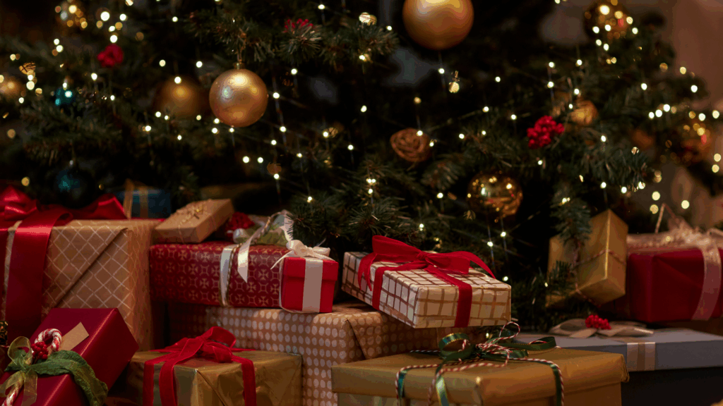 An image of a festive Christmas tree with wrapped presents underneath