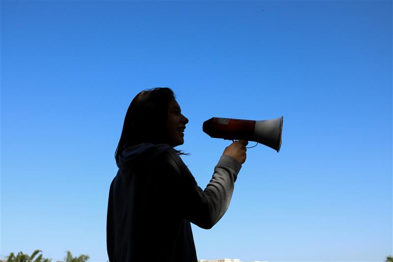 A silhouette of a woman holding a megaphone - resembling the need for brand consistency
