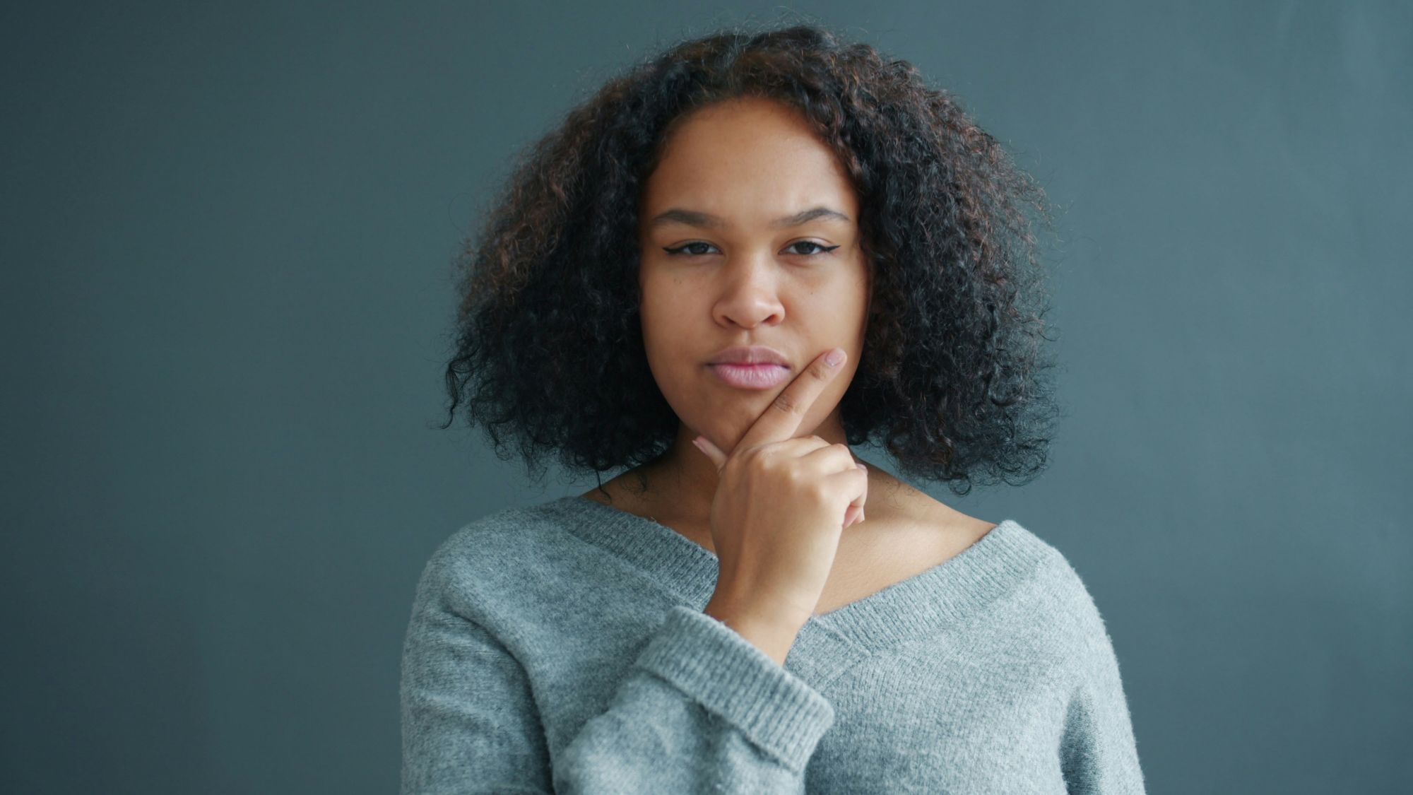 A picture of woman looking investigative, intended to reflect the question of the blog - Are you suffering from a Relevance Gap? Five signs your marketing isn't connecting with HR leaders