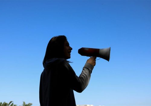 A silhouette of a woman holding a megaphone - resembling the need for brand consistency